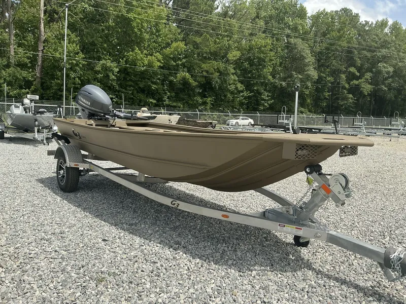 Slide: The Image of 2025 G3 Gator Tough 15 DK boat on trailer, parked on gravel lot. - 9