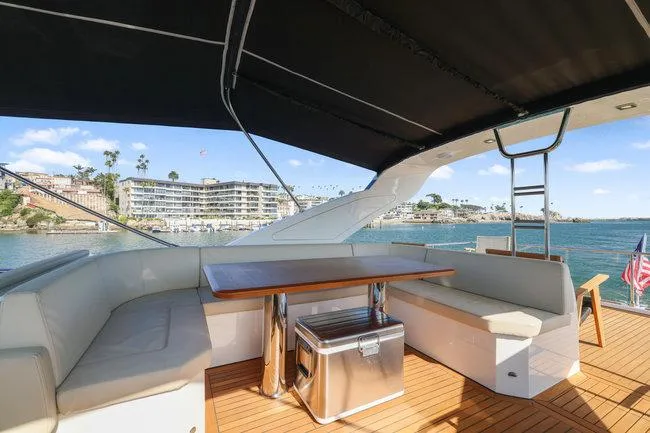 Slide: The Image of Luxurious 2015 Absolute Fly yacht deck with seating, table, and scenic waterfront view. - 12