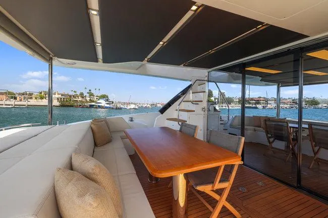 Slide: The Image of Luxurious yacht deck with seating, wooden table, and ocean view; Absolute Fly 2015 model. - 16