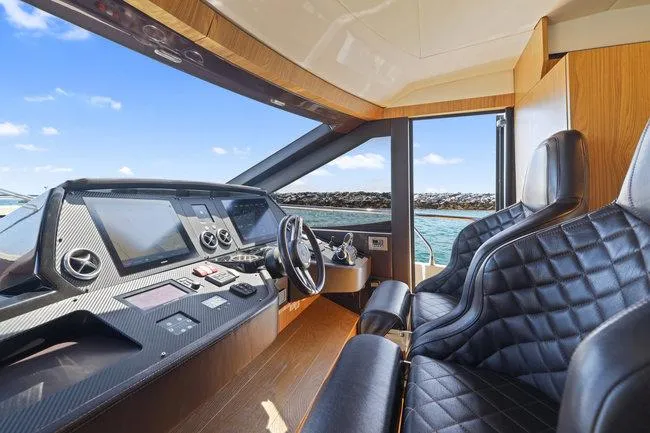Slide: The Image of Luxurious yacht cockpit with leather seats, modern controls, and ocean view. Absolute Fly 2015 model. - 27
