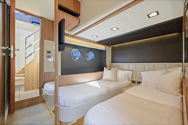 Slide: The Image of Luxurious yacht bedroom with twin beds, modern design, and porthole windows on Absolute Fly 2015. - 31