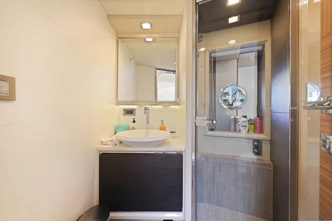 Slide: The Image of Luxurious yacht bathroom with modern fixtures, glass shower, and elegant design, 2015 Absolute Fly model. - 32