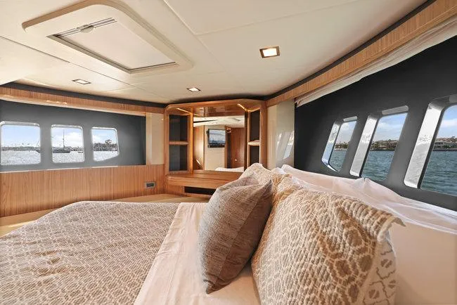 Slide: The Image of Luxurious yacht bedroom interior with large windows, modern design, and elegant bedding. - 35