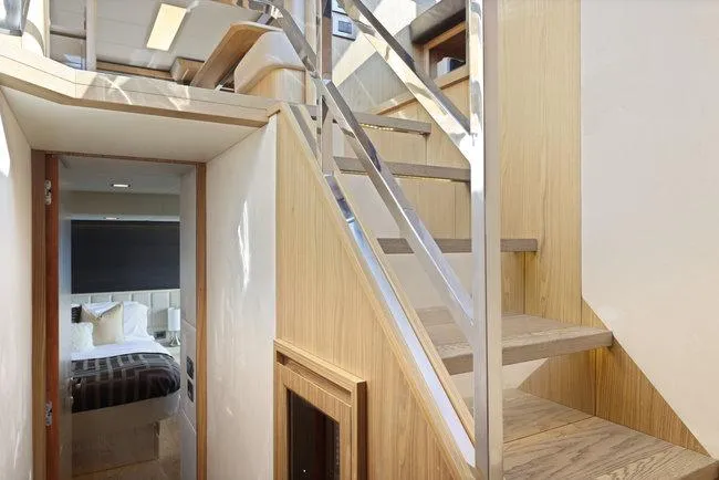 Slide: The Image of Interior of 2015 Absolute Fly yacht, featuring modern staircase and cozy bedroom. - 38