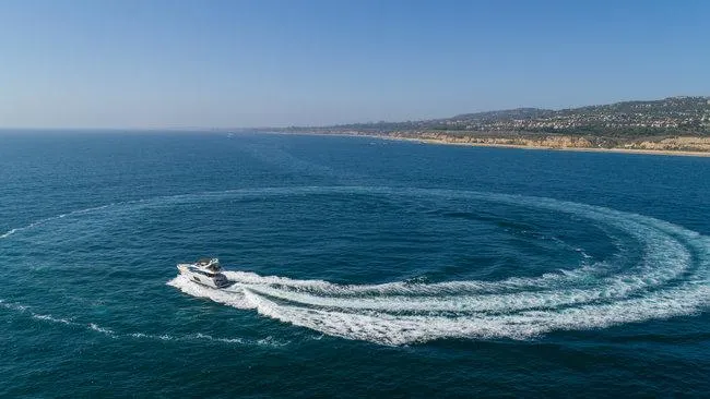 Slide: The Image of Yacht making circular waves in ocean, near coastline; Absolute Fly, 2015 model. - 4