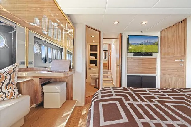 Slide: The Image of Luxurious yacht interior with modern design, featuring a bedroom, desk, and TV. Absolute Fly 2015 model. - 42