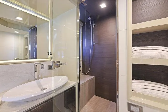 Slide: The Image of Luxurious yacht bathroom with modern shower, sleek sink, and neatly stacked towels, 2015 Absolute Fly. - 46