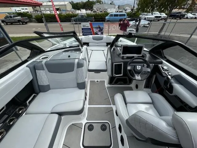 Slide: The Image of 2021 Malibu M240 boat interior with modern seating and dashboard, showcasing luxury and comfort. - 12