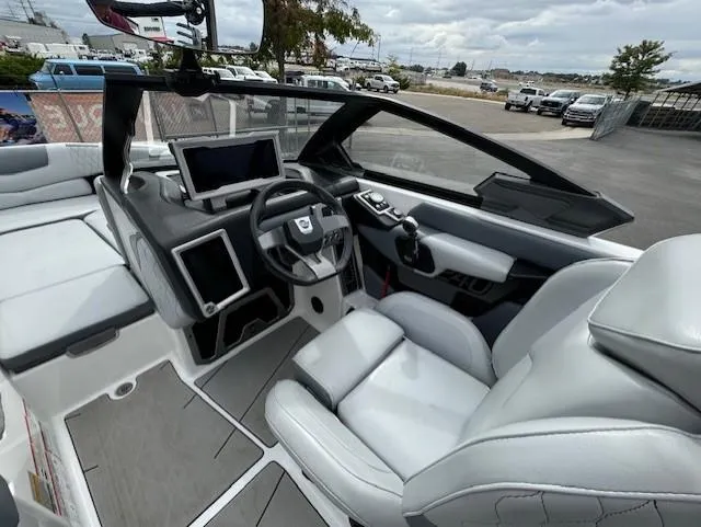Slide: The Image of 2021 Malibu M240 boat interior with modern dashboard and comfortable seating. - 15