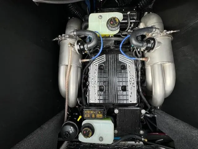 Slide: The Image of 2021 Malibu M240 engine with supercharger, showcasing intricate components and dual exhausts. - 20