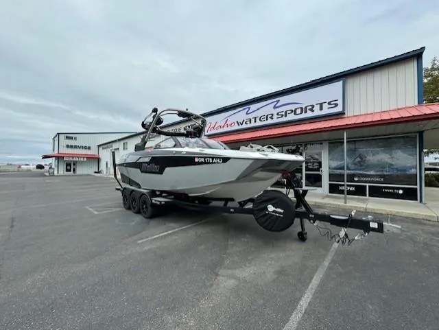 Slide: The Image of 2021 Malibu M240 boat on trailer at Idaho Water Sports dealership. - 9