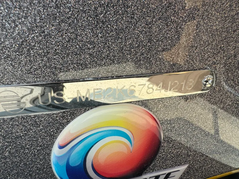 Slide: The Image of 2013 Malibu WVLX boat hull identification number with colorful logo on metallic surface. - 15