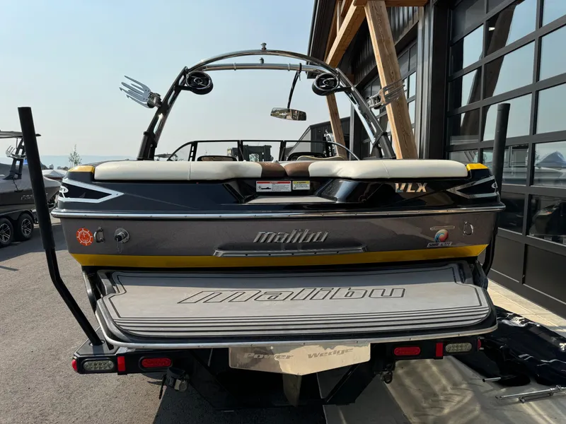 Slide: The Image of 2013 Malibu WVLX boat rear view with wakeboard tower and swim platform. - 5