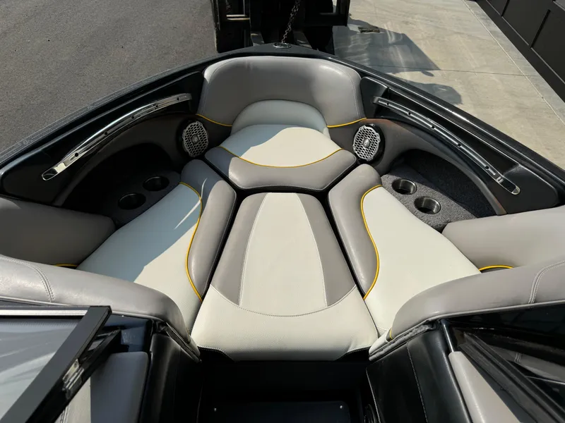 Slide: The Image of 2013 Malibu WVLX boat interior with cushioned seating and cup holders. - 6