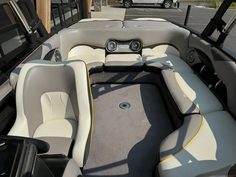 Slide: The Image of Interior of a 2013 Malibu WVLX boat with beige and gray seating. - 7