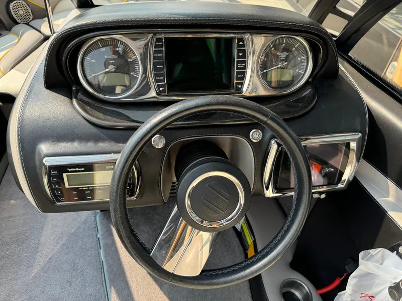 Slide: The Image of Dashboard of a 2013 Malibu WVLX boat with steering wheel and gauges. - 8