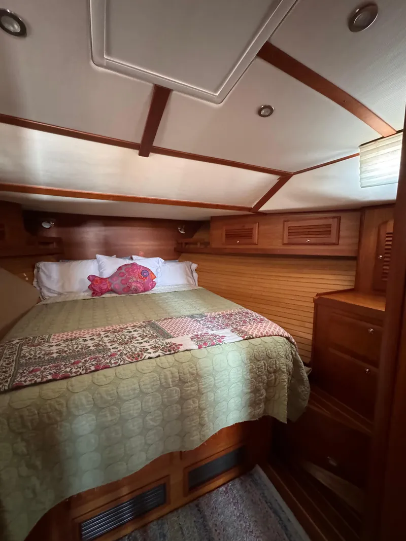 Slide: The Image of Cozy cabin interior of 2005 Sabre 38 sailboat with wood finish and quilted bedding. - 11
