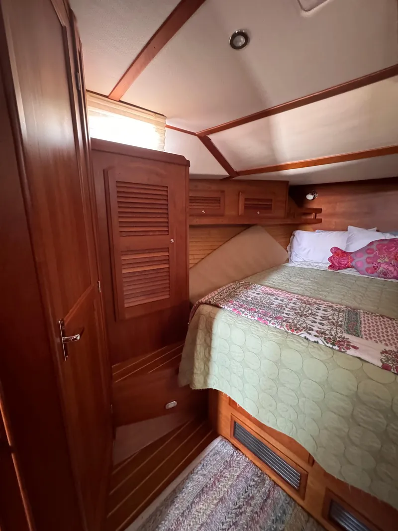 Slide: The Image of Cozy cabin interior of 2005 Sabre 38 sailboat with wooden furnishings and bed. - 12