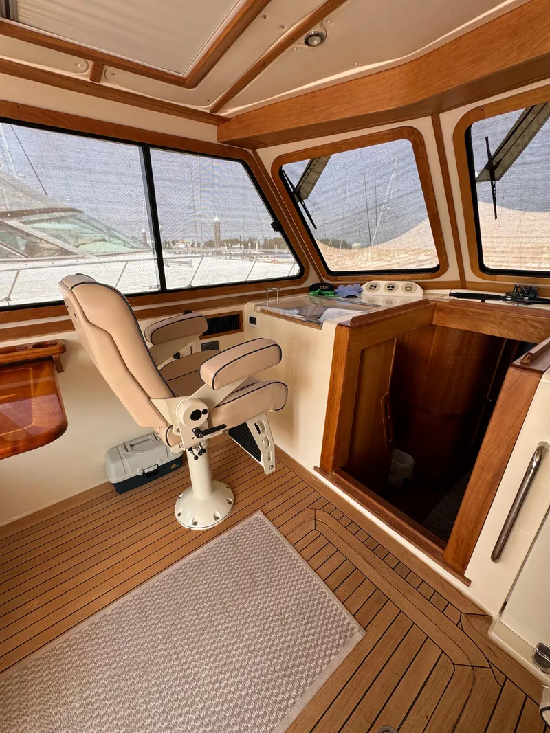 Slide: The Image of Interior of 2005 Sabre 38 boat with wooden accents and captain's chair. - 16