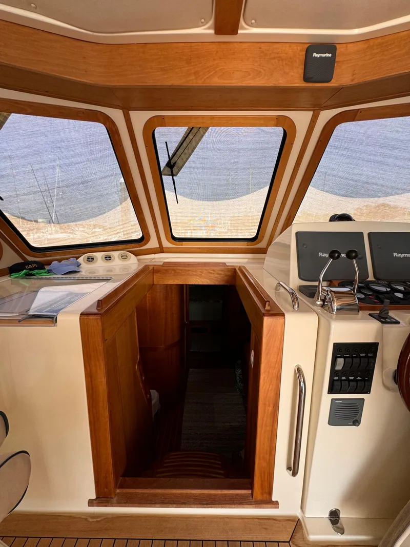 Slide: The Image of 2005 Sabre 38 yacht interior with wooden finish and navigation equipment. - 18