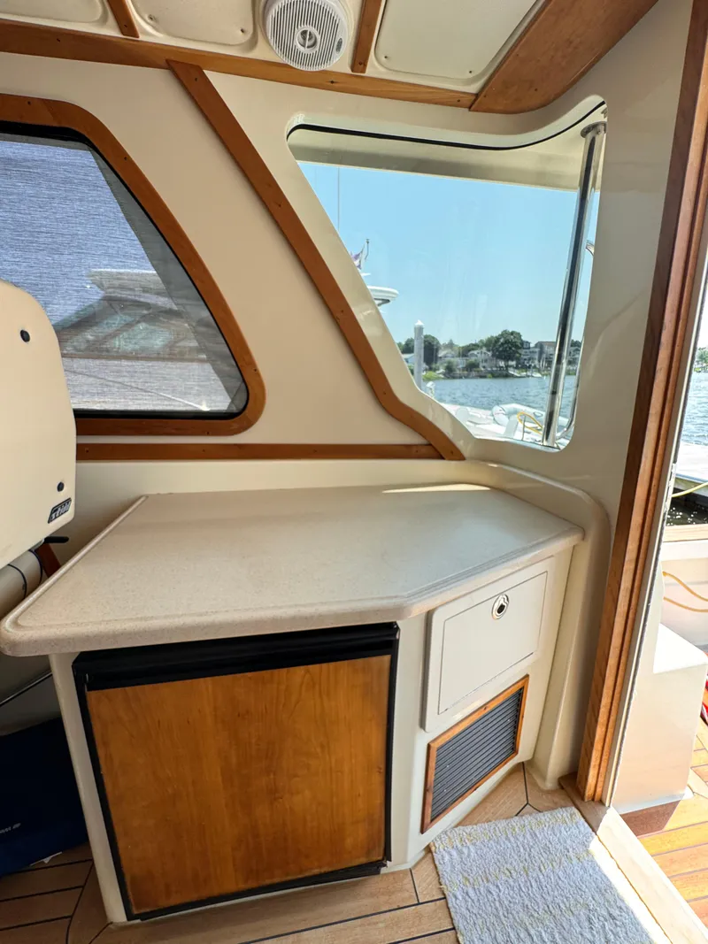 Slide: The Image of Interior of 2005 Sabre 38 boat with wooden cabinetry and window view. - 20