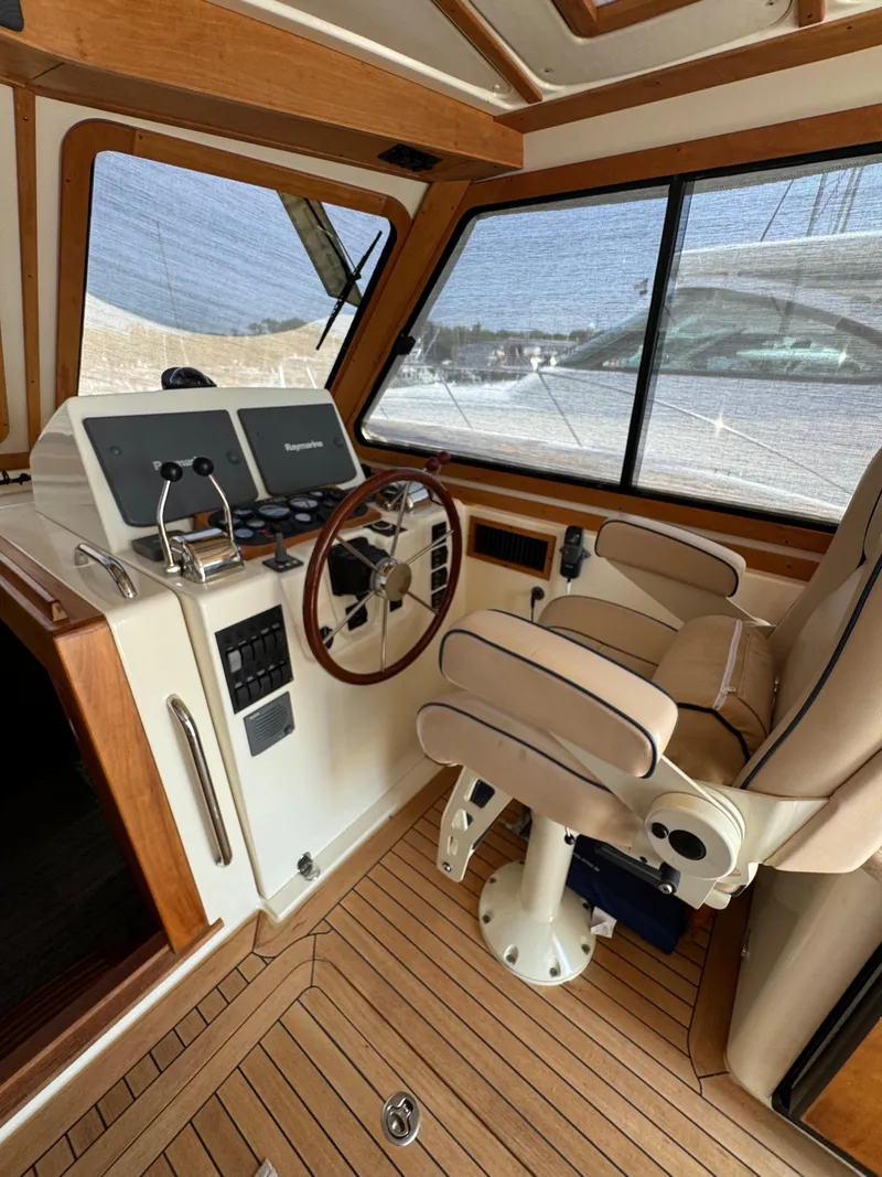 Slide: The Image of Interior of 2005 Sabre 38 boat with helm, steering wheel, and captain's chair. - 22