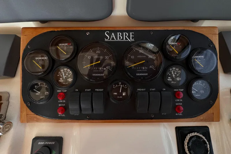 Slide: The Image of Control panel of a 2005 Sabre 38 boat with various gauges and switches. - 23