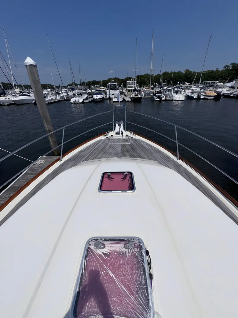 Slide: The Image of 2005 Sabre 38 yacht docked in a marina, surrounded by boats. - 31