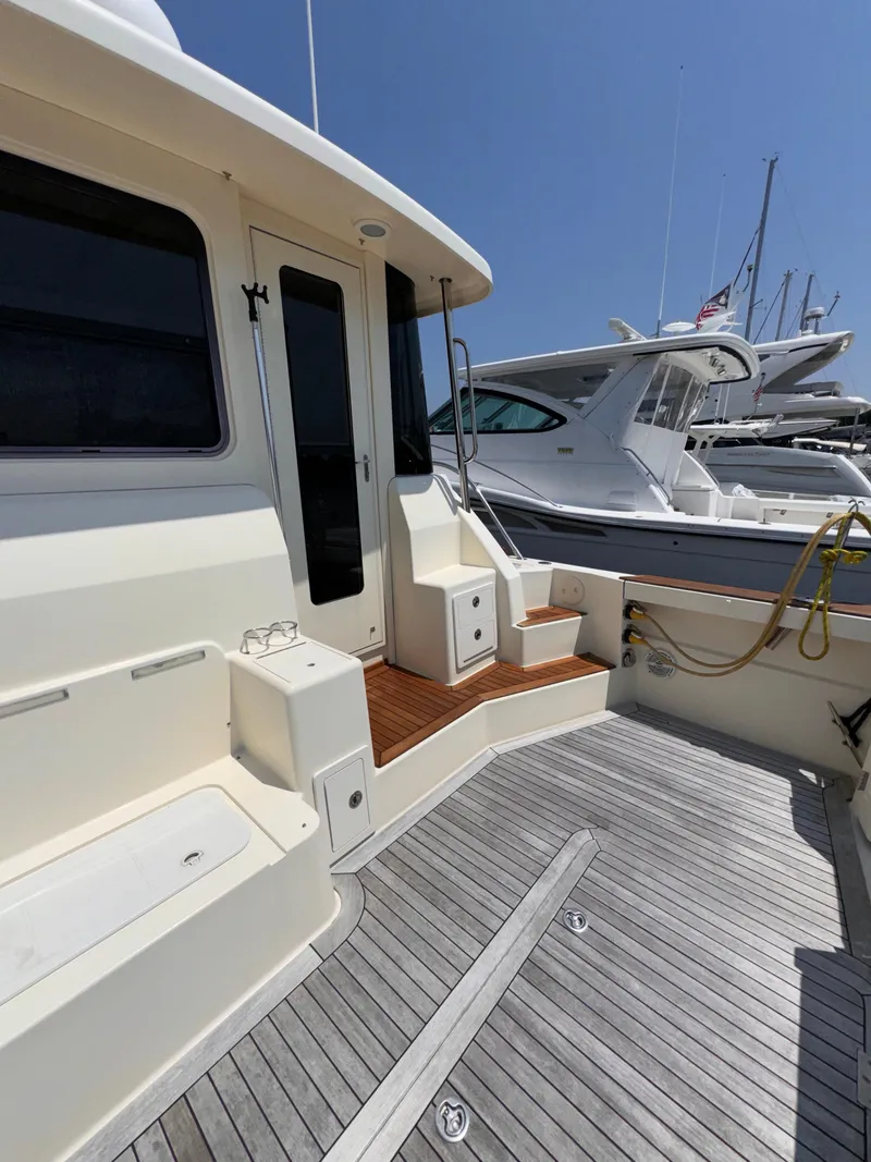 Slide: The Image of 2005 Sabre 38 yacht deck with wooden steps and seating area. - 34