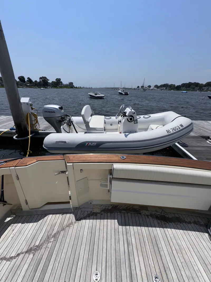 Slide: The Image of 2005 Sabre 38 yacht docked with inflatable boat on calm waters. - 38