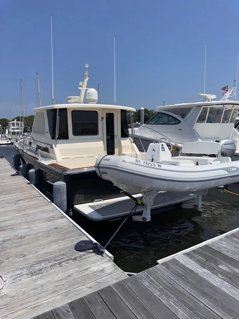Slide: The Image of 2005 Sabre 38 yacht docked with inflatable boat, sunny day. - 4
