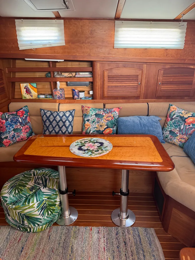 Slide: The Image of Interior of 2005 Sabre 38 yacht with colorful cushions and wooden table. - 8