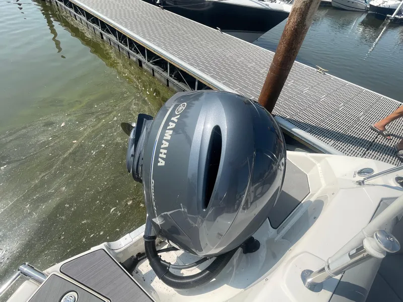 Slide: The Image of 2021 NauticStar 223 DC Deck boat with Yamaha outboard motor at dock. - 17