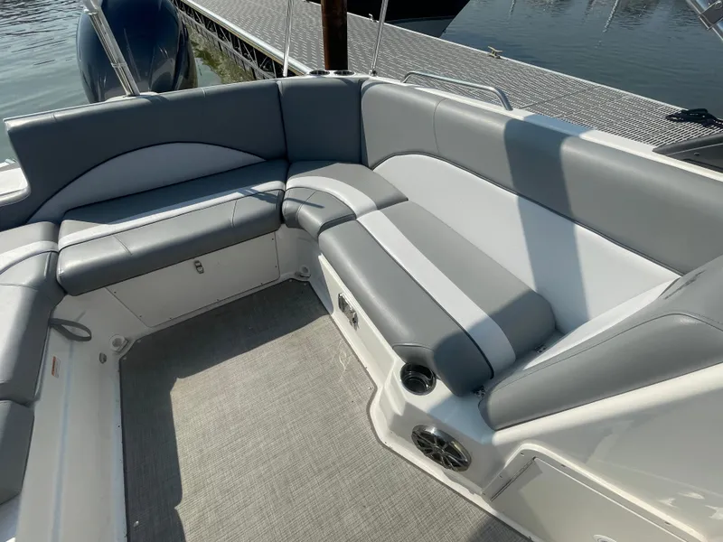 Slide: The Image of 2021 NauticStar 223 DC Deck boat interior with gray seating and speaker system. - 6