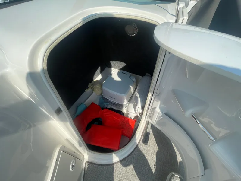 Slide: The Image of Interior storage compartment of 2021 NauticStar 223 DC Deck boat with safety equipment. - 8