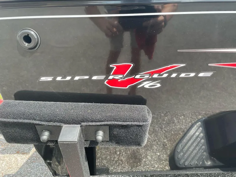 Slide: The Image of 2025 Tracker Super Guide V-16 SC boat logo on black surface. - 2