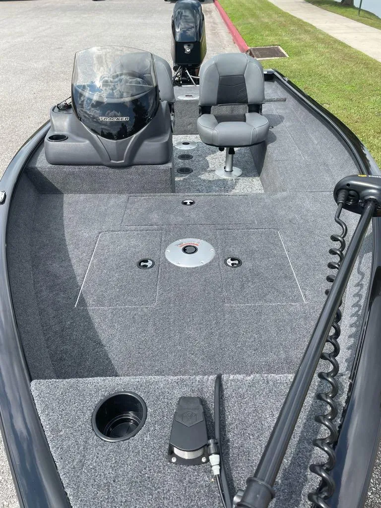Slide: The Image of 2025 Tracker Super Guide V-16 SC fishing boat interior with seating and control panel. - 3