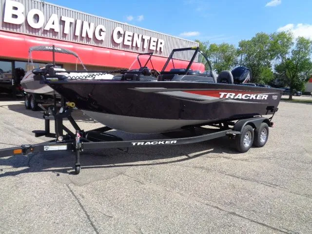 Slide: The Image of 2025 Tracker Targa V-18 Combo boat on trailer at boating center. - 2