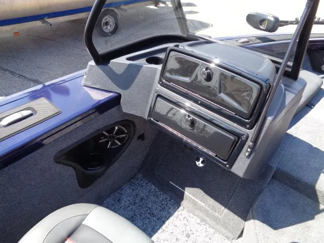 Slide: The Image of 2025 Tracker Targa V-18 Combo boat interior with storage compartments and speaker. - 8