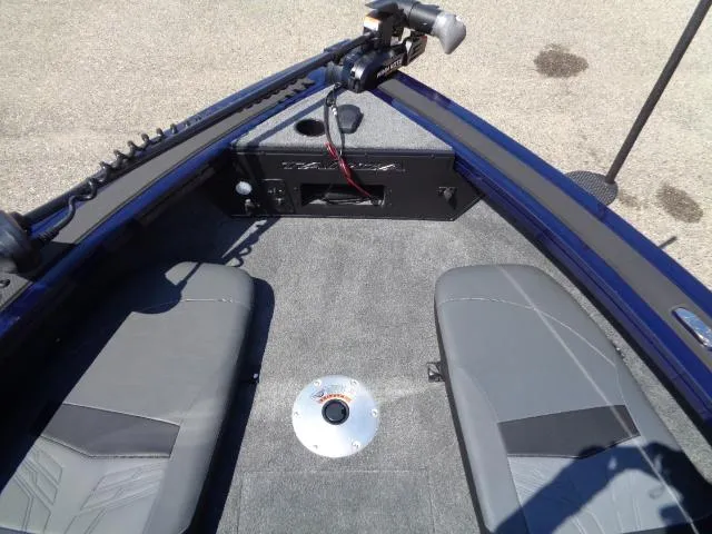Slide: The Image of 2025 Tracker Targa V-18 Combo boat interior with gray seating and fishing equipment. - 9