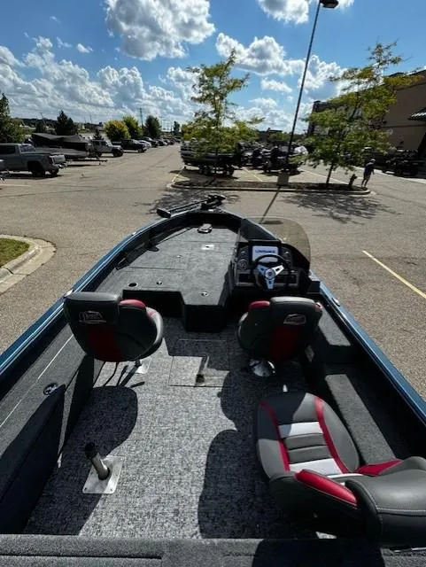 Slide: The Image of 2024 Ranger VS1782SC Angler boat with seating, parked outdoors under a cloudy sky. - 3