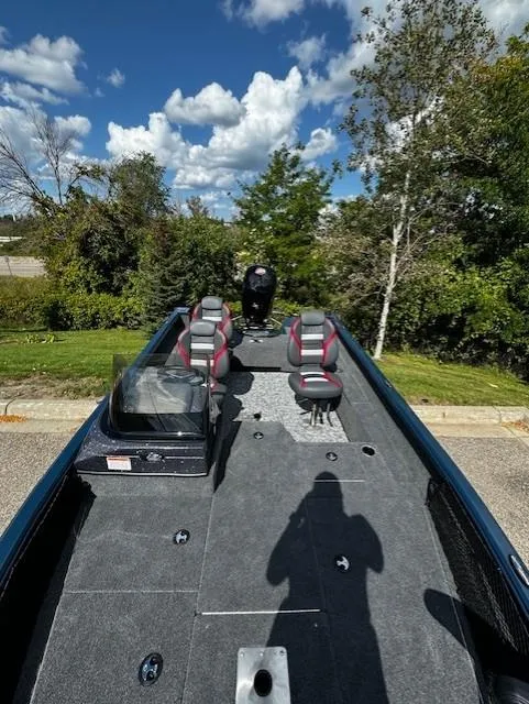 Slide: The Image of 2024 Ranger VS1782SC Angler boat with seating, parked outdoors under a blue sky. - 4