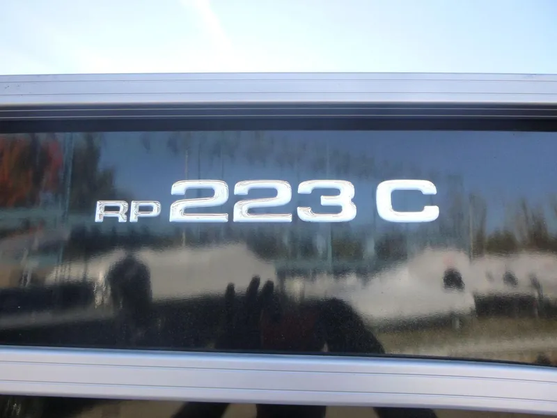 Slide: The Image of Close-up of 2024 Ranger Reata 223C model emblem on a reflective surface. - 3