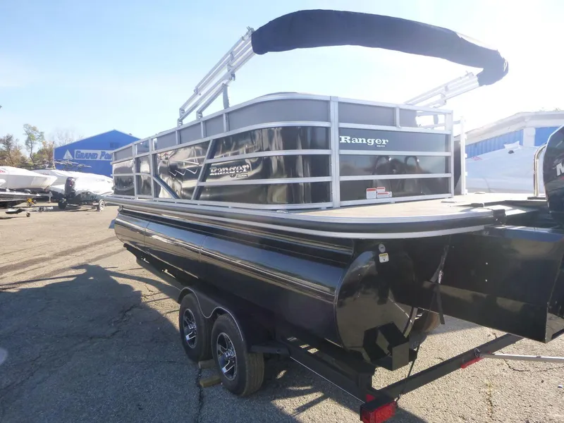 Slide: The Image of 2024 Ranger Reata 223C pontoon boat on trailer, outdoor display. - 5