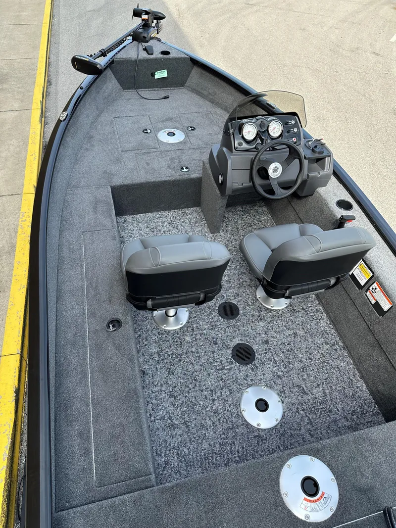 Slide: The Image of 2025 Tracker Super Guide V-16 SC boat interior with dual seats and steering console. - 4