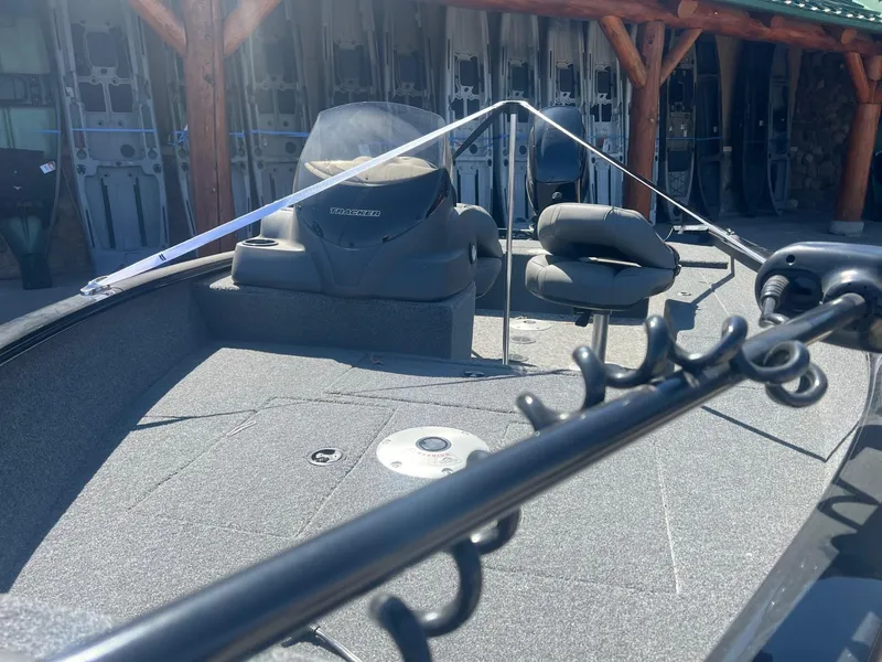 Slide: The Image of 2025 Tracker Super Guide V-16 SC boat interior with seating and fishing rod holder. - 4