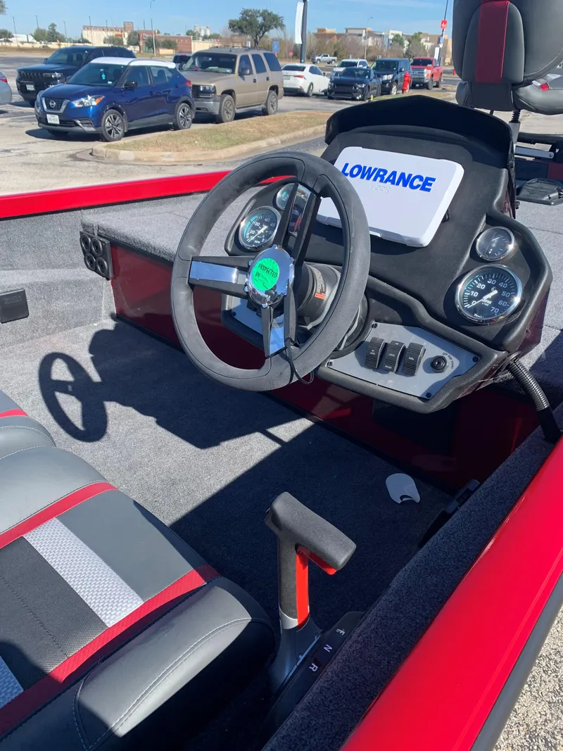 Slide: The Image of 2024 Ranger RT188 boat interior with steering wheel and Lowrance electronics. - 2