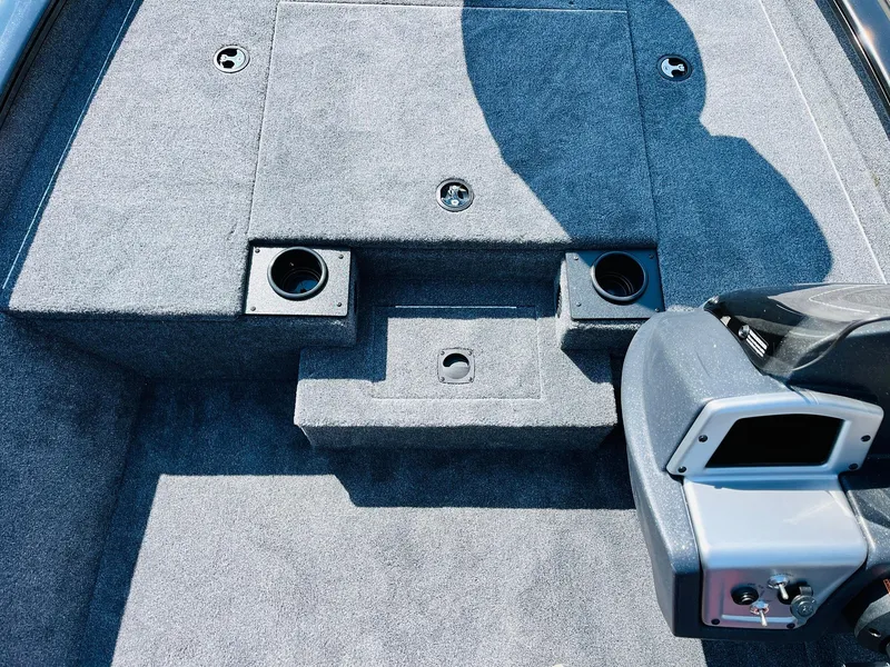 Slide: The Image of 2025 Tracker Pro Team 175 boat interior with carpeted deck and seating area. - 18