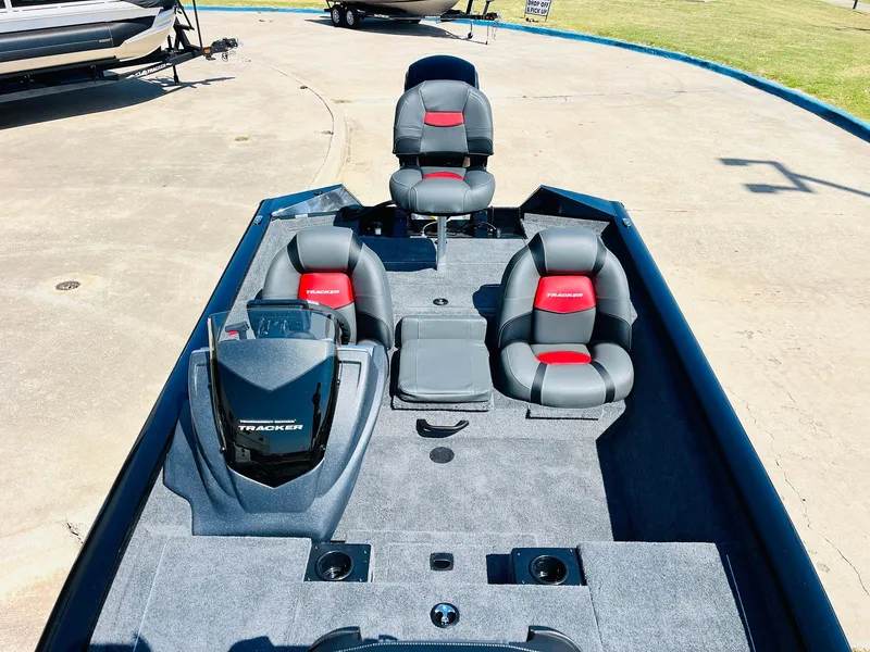Slide: The Image of 2025 Tracker Pro Team 175 boat interior with gray and red seating, spacious deck layout. - 20