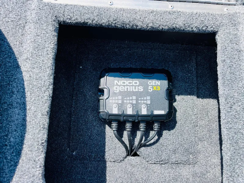 Slide: The Image of NOCO Genius GEN5X3 charger in 2025 Tracker Pro Team 175 boat compartment. - 23